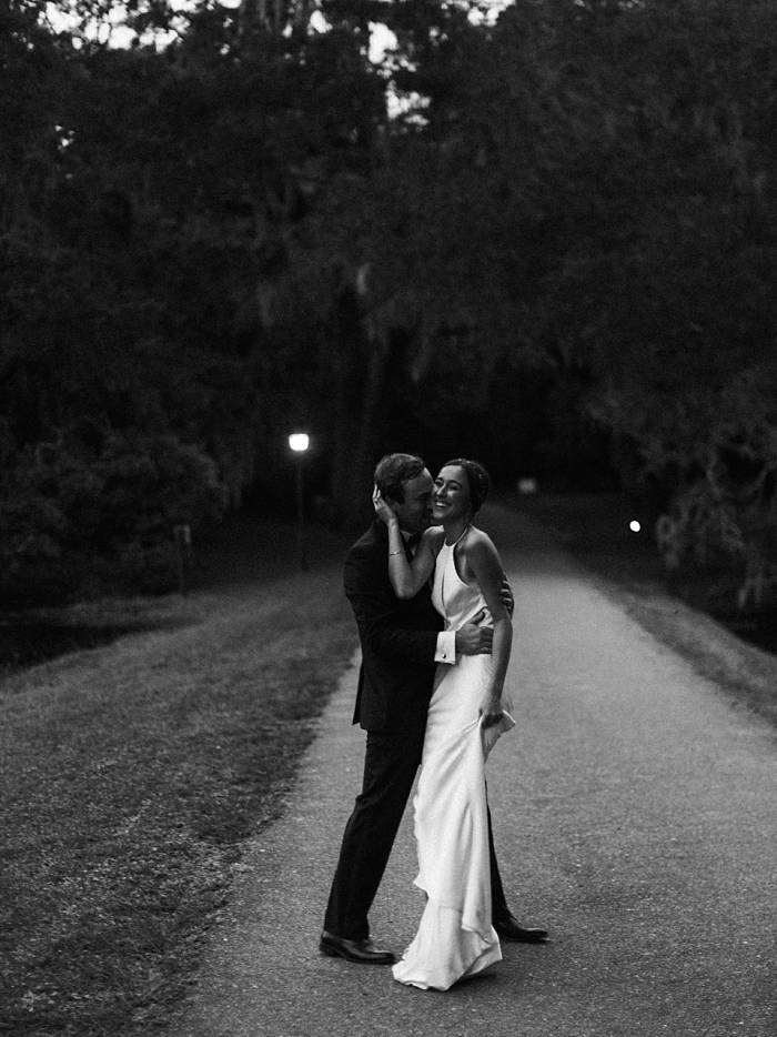 documentary photography black and white portrait of bride and groom dancing at charleston wedding venue legare waring house