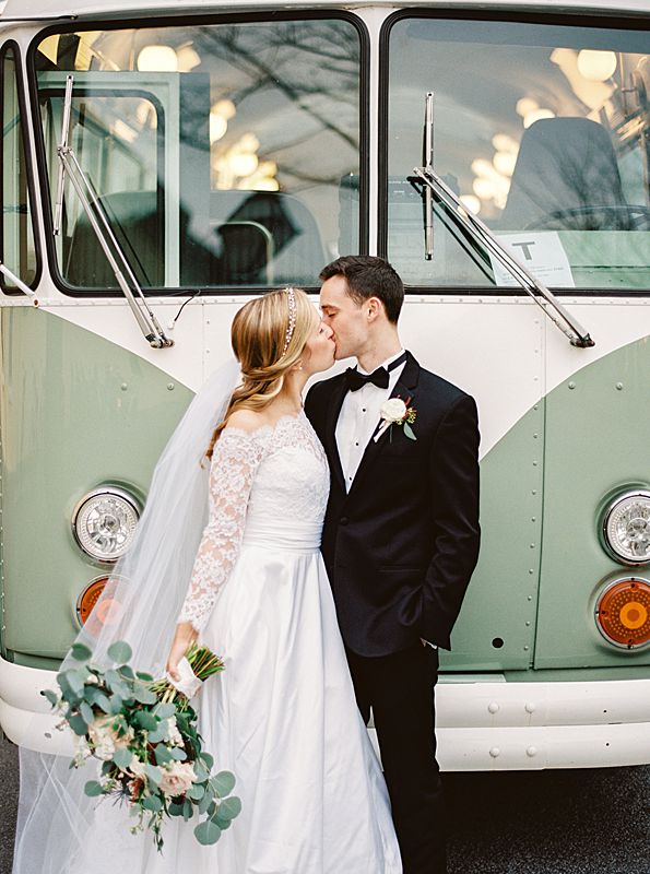 lowcountry vintage bus transportation with bride and groom in front for film portrait at a william aiken house charleston wedding in february