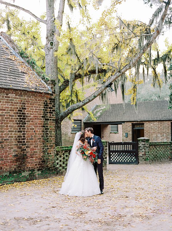 fall middleton place wedding portrait on kodak portra 800 film in charleston south carolina with blooming yellow tree and colorful bouquet