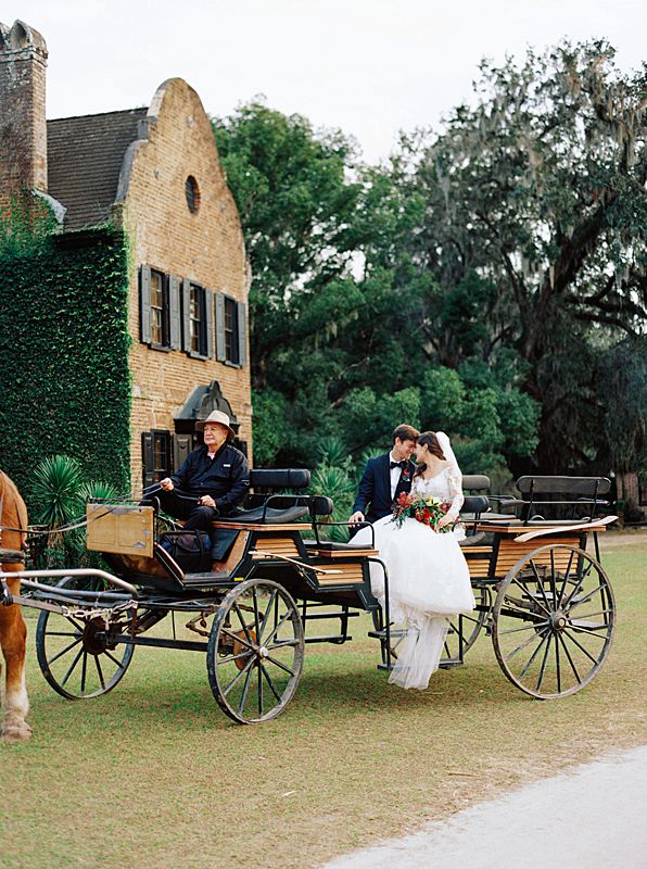 bride and groom on carriage in front of inn at middleton place in charleston south carolina by film wedding photographer brian d smith