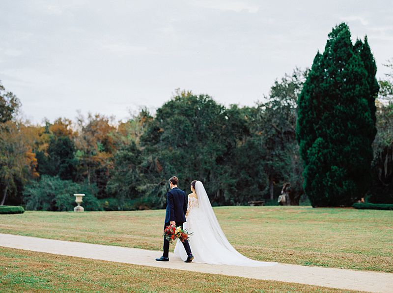 middleton place charleston wedding venue with fall colors and bride and groom walking on kodak portra 800 film